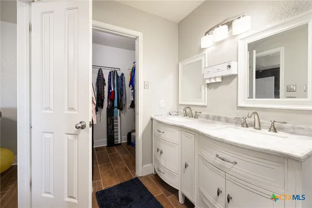 a bathroom with a double vanity sink and a mirror