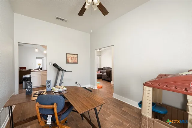 a workspace with furniture and wooden floor