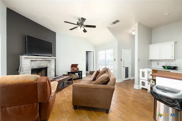 a living room with fireplace furniture and a flat screen tv