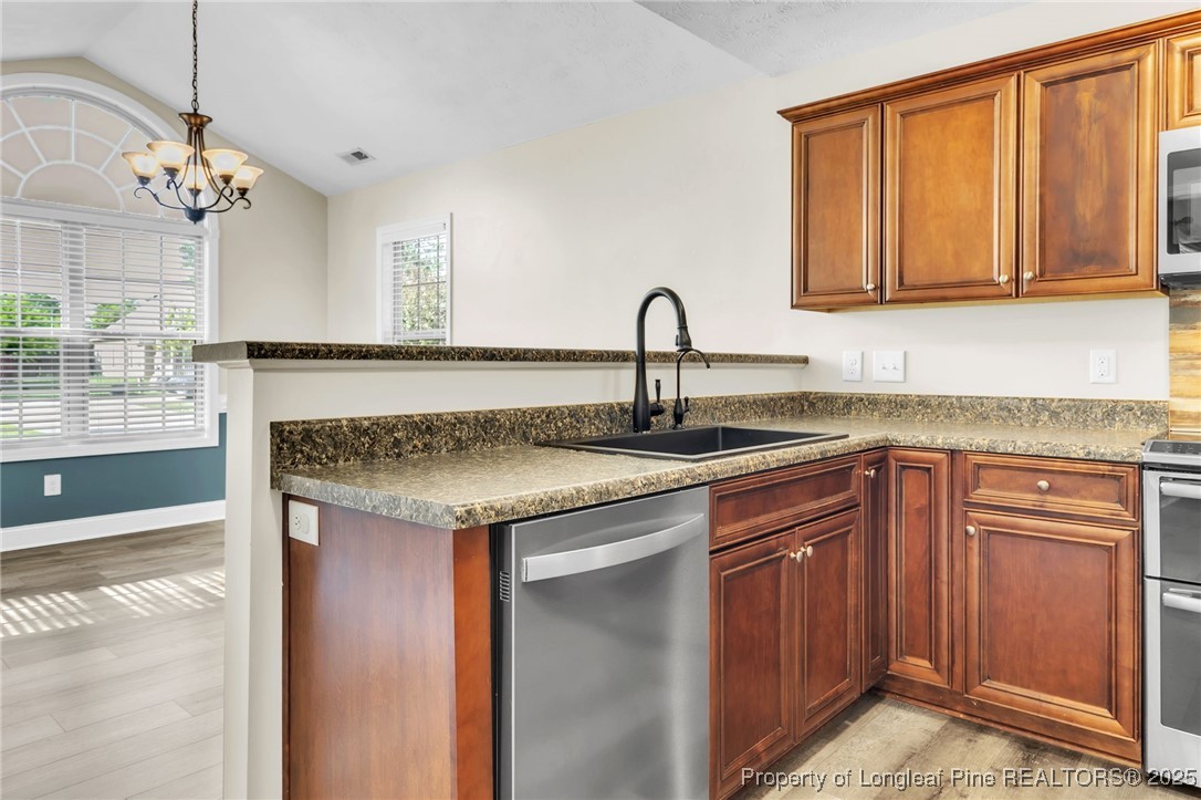 510 Hammond Farms Road Hope Mills, NC 28348 - Photo 13 of 49 a kitchen with stainless steel appliances granite countertop a sink and cabinets