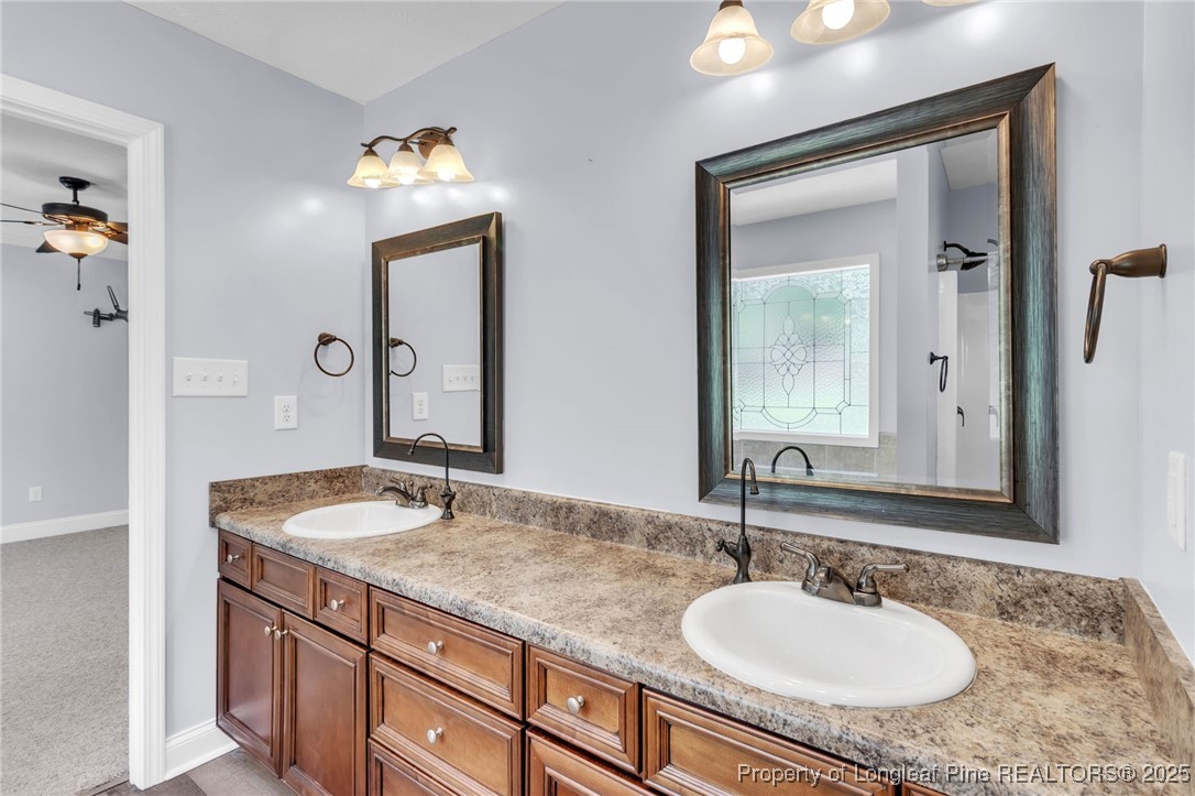 510 Hammond Farms Road Hope Mills, NC 28348 - Photo 21 of 49 a bathroom with a granite countertop sink and a mirror