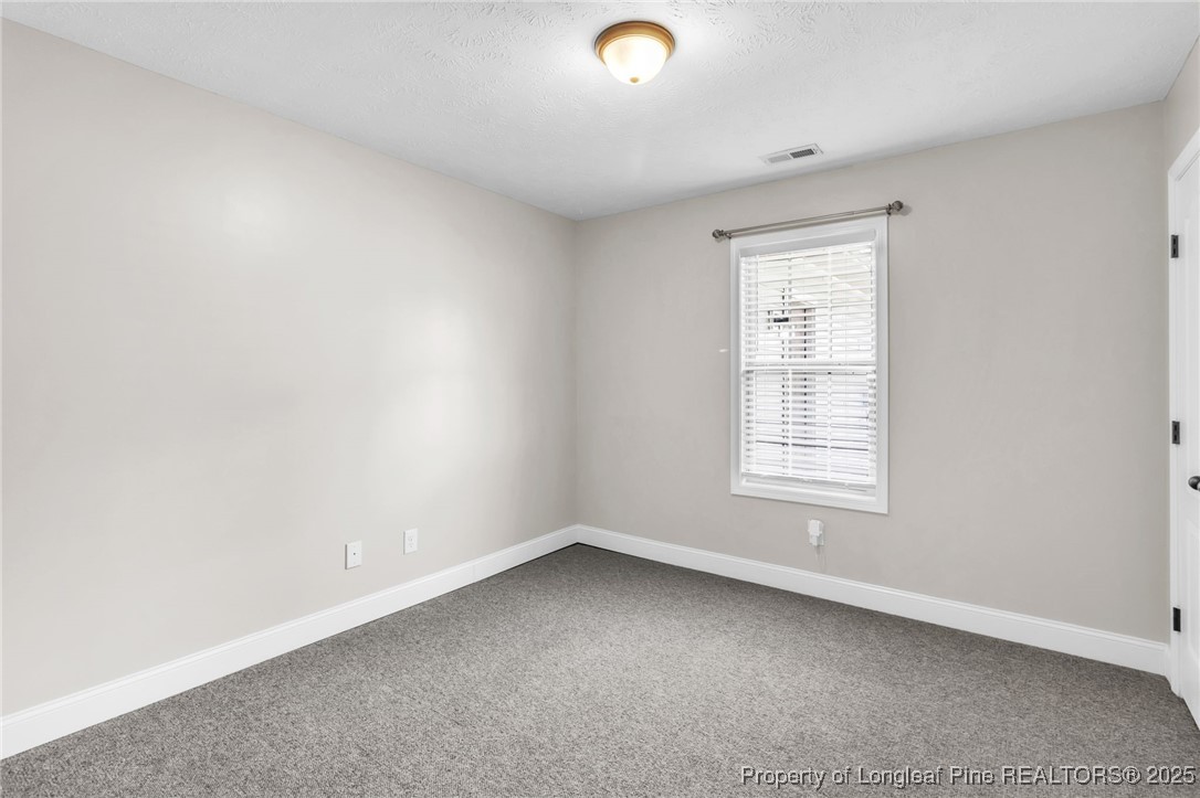 510 Hammond Farms Road Hope Mills, NC 28348 - Photo 22 of 49 an empty room with a window