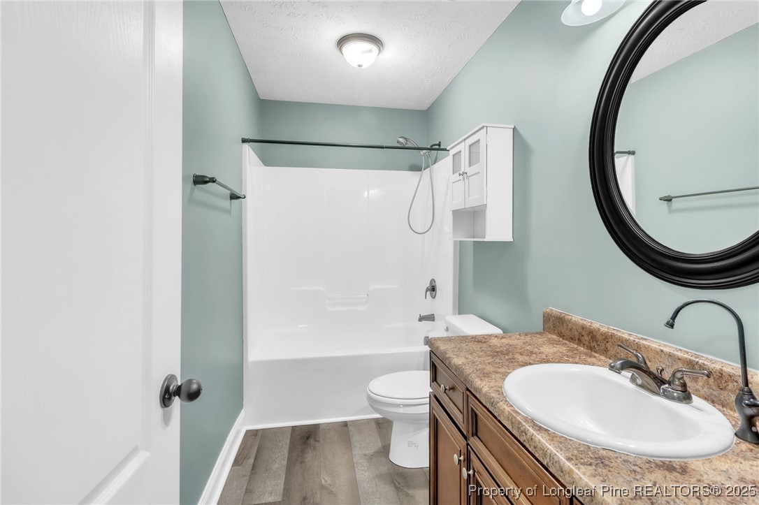 510 Hammond Farms Road Hope Mills, NC 28348 - Photo 24 of 49 a bathroom with a granite countertop sink toilet and shower