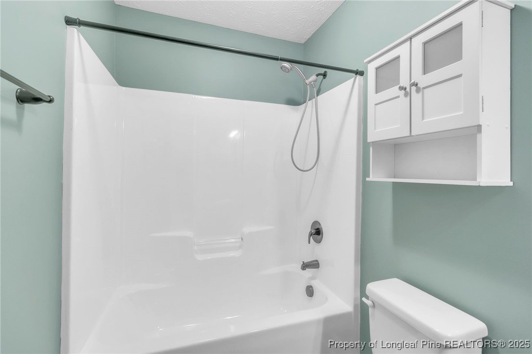 510 Hammond Farms Road Hope Mills, NC 28348 - Photo 25 of 49 a bathroom with a shower and a toilet