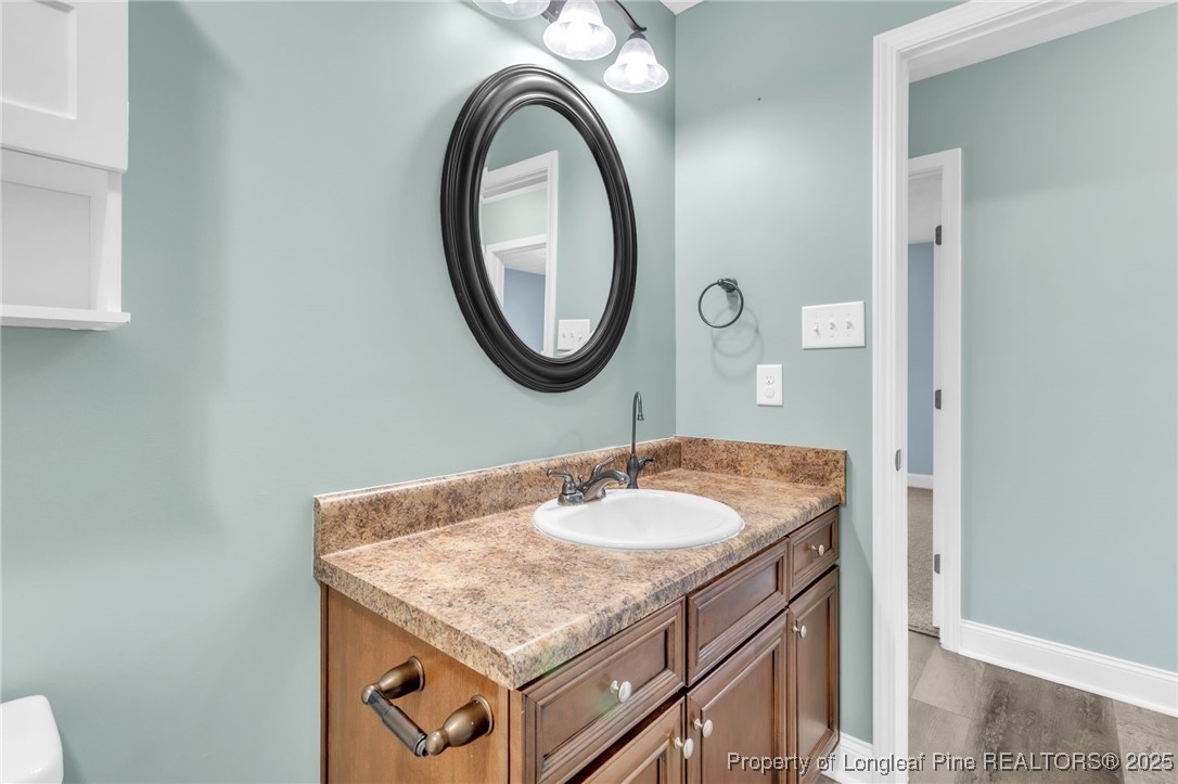 510 Hammond Farms Road Hope Mills, NC 28348 - Photo 26 of 49 a bathroom with a granite countertop sink and a mirror