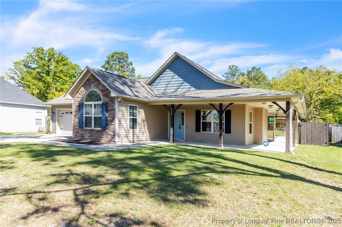 510 Hammond Farms Road Hope Mills, NC 28348 - Photo 3 of 49 a view of a house with a swimming pool and a yard