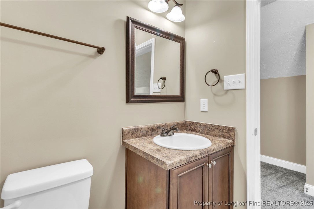 510 Hammond Farms Road Hope Mills, NC 28348 - Photo 33 of 49 a bathroom with a toilet sink and mirror