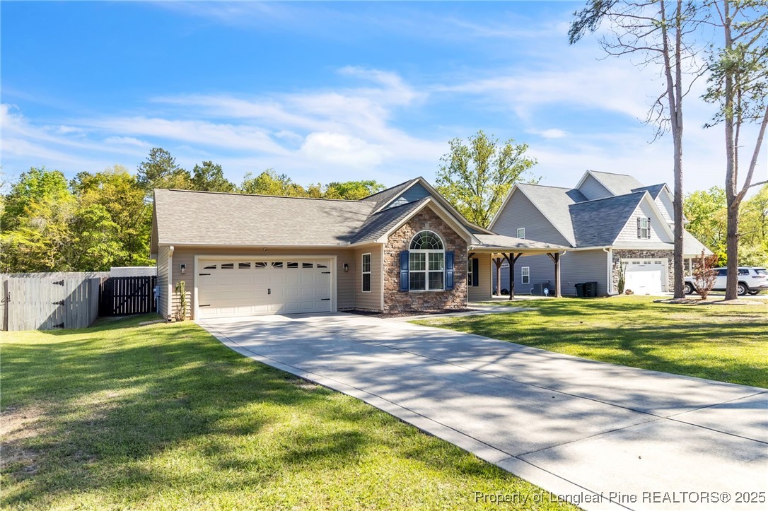 510 Hammond Farms Road Hope Mills, NC 28348 - Photo 45 of 49 a view of a house with a big yard and large trees