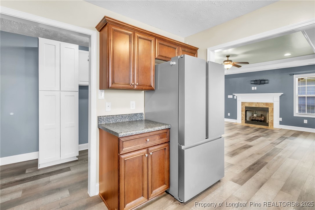 510 Hammond Farms Road Hope Mills, NC 28348 - Photo 10 of 49 a kitchen with stainless steel appliances granite countertop a refrigerator a stove and a sink with wooden floor
