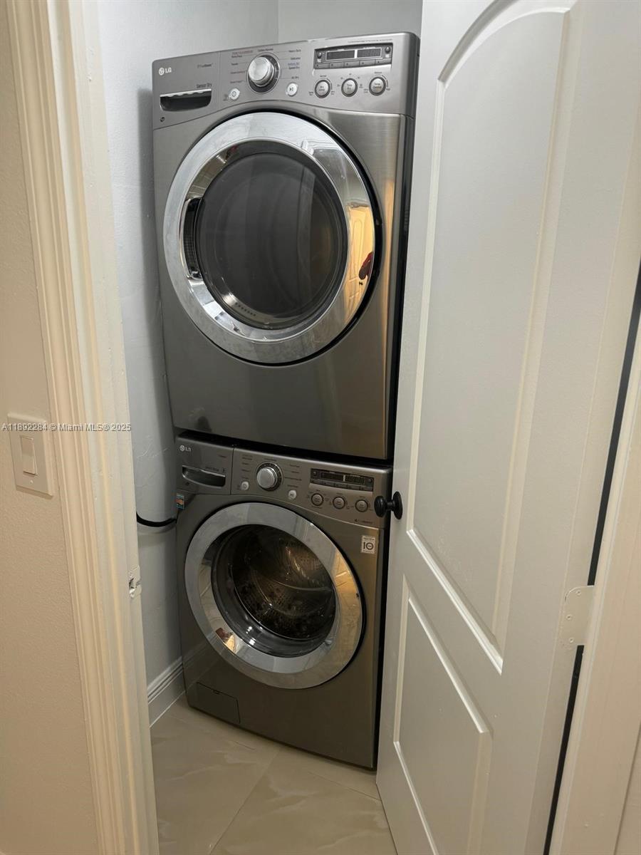 18101 Northwest 68th Avenue, Unit D207 Hialeah, FL 33015 - Photo 11 of 18 a utility room with dryer and washer