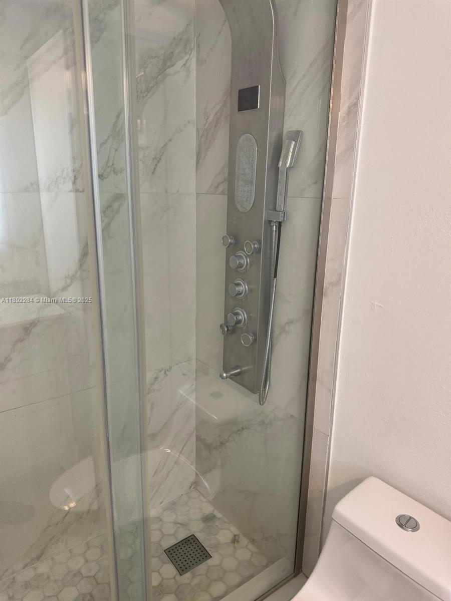18101 Northwest 68th Avenue, Unit D207 Hialeah, FL 33015 - Photo 18 of 18 a bathroom with a shower and toilet