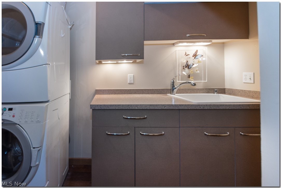 1237 Washington Avenue, Unit 1209 Cleveland, OH 44113 - Photo 26 of 33 1ST FLOOR IN HOUSE LAUNDRY ROOM W/FULL SZ STACKABLE WASHER/DRYER UTLITY SINK/VANITY/ STORAGE
