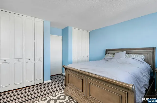 a bedroom with a bed and cabinets