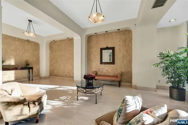 a living room with furniture and a potted plant