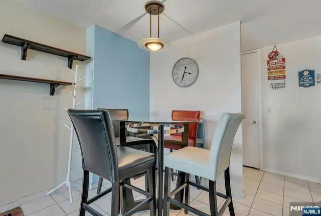 a view of a dining room with a table and chairs