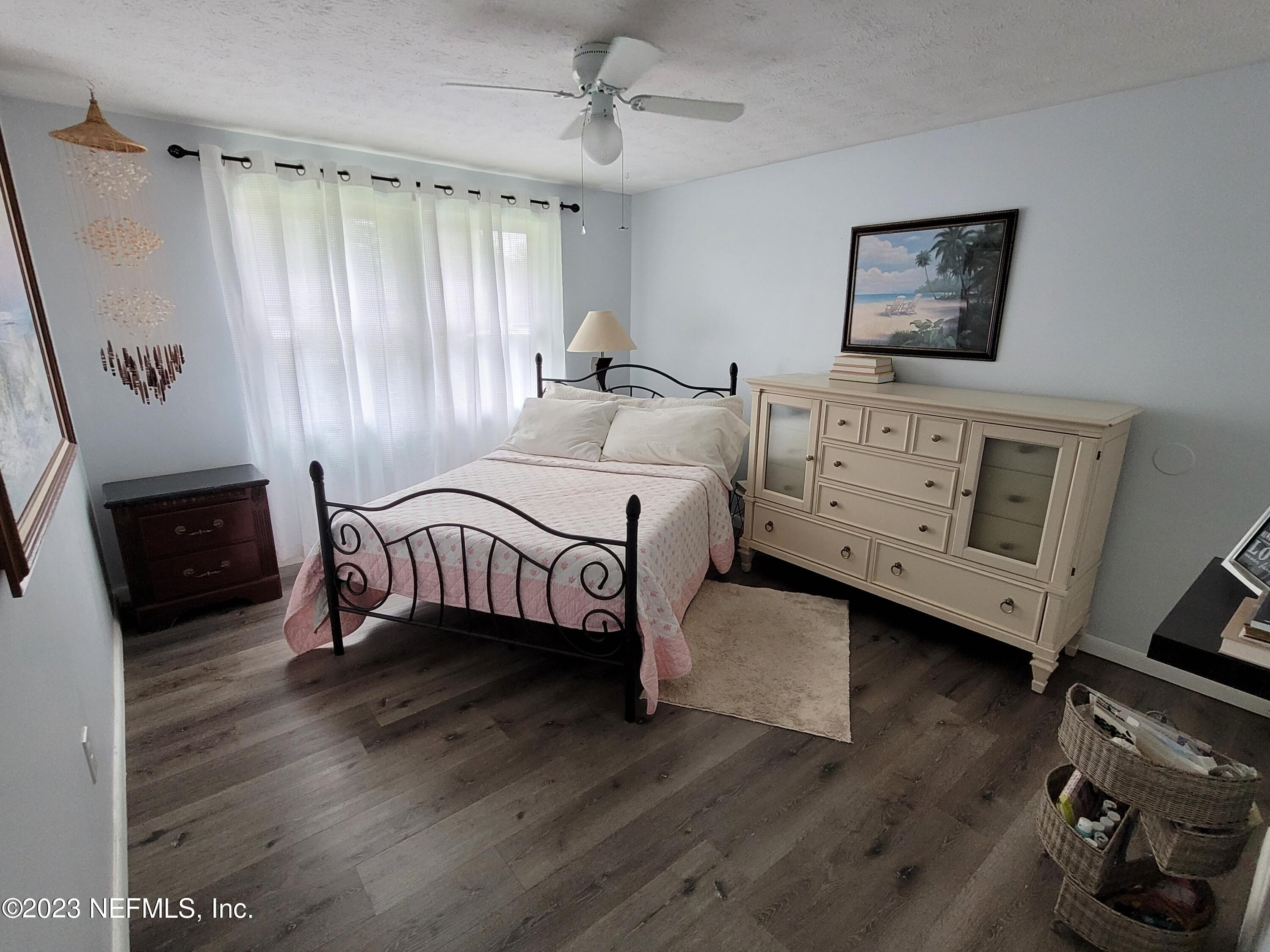 1050 Perkins Place Jacksonville, FL 32221 - Photo 12 of 18 a bedroom with furniture and a wooden floor