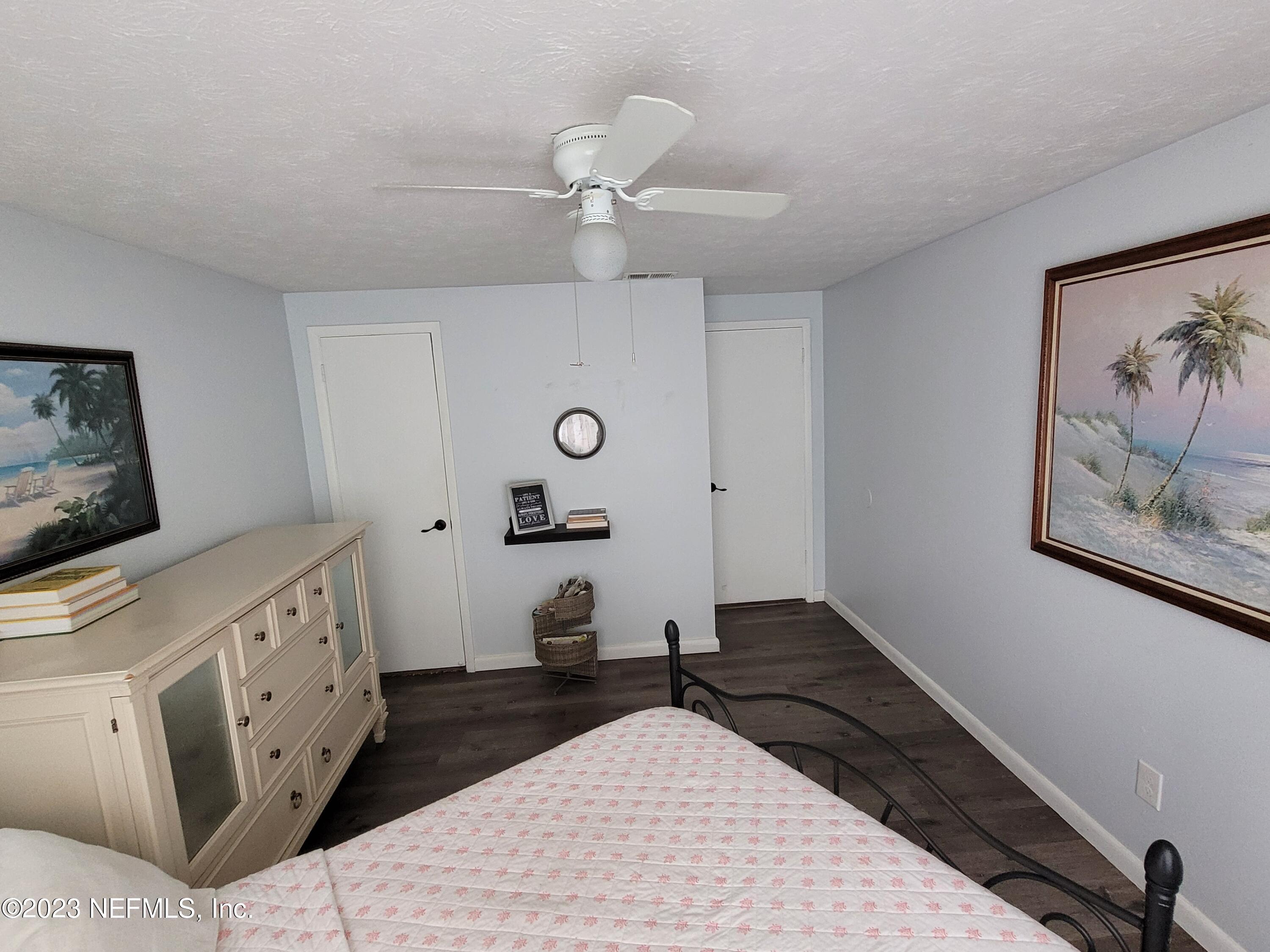 1050 Perkins Place Jacksonville, FL 32221 - Photo 13 of 18 a bedroom with a bed and a chandelier