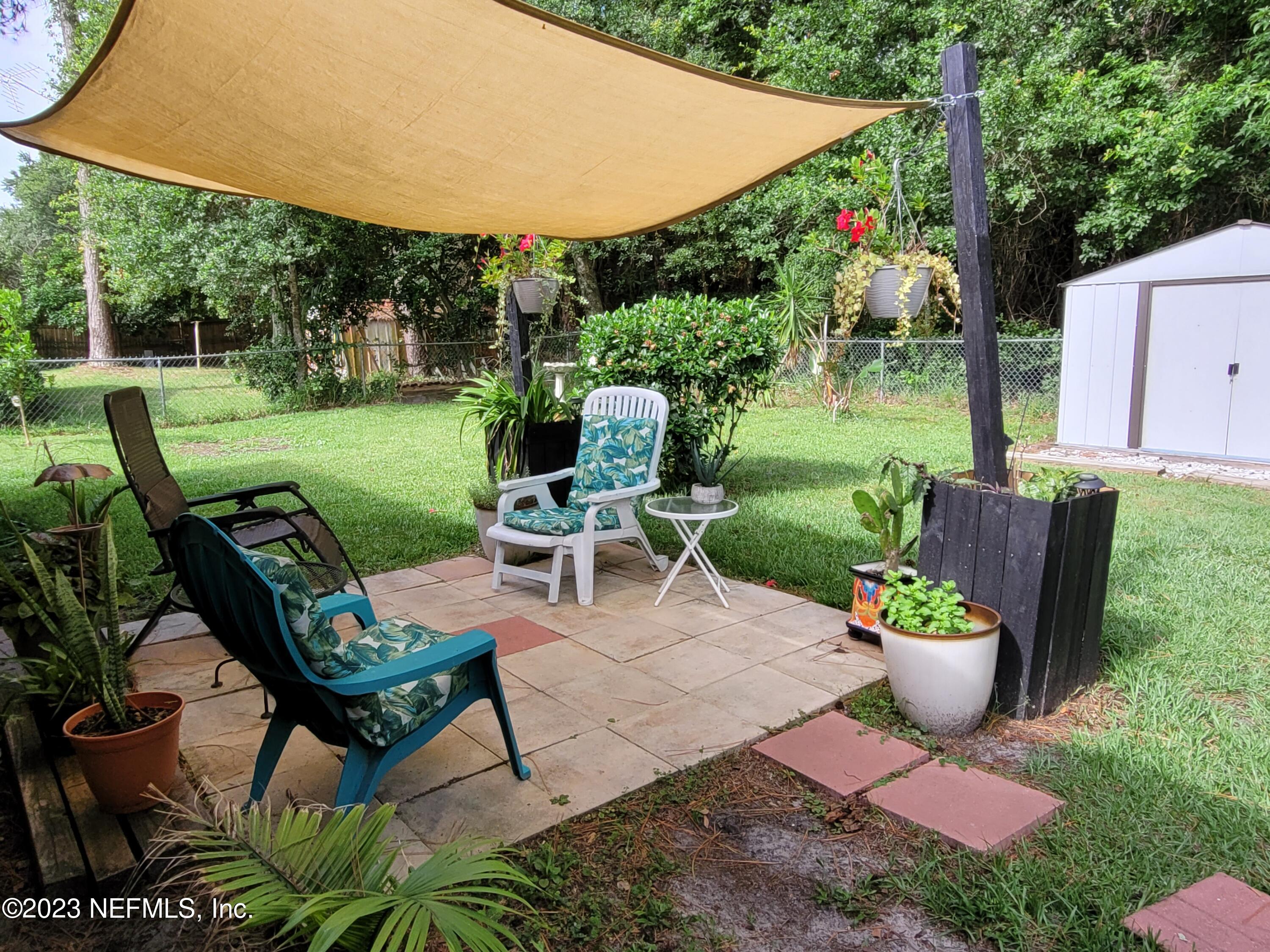 1050 Perkins Place Jacksonville, FL 32221 - Photo 16 of 18 a view of a backyard with sitting area and garden