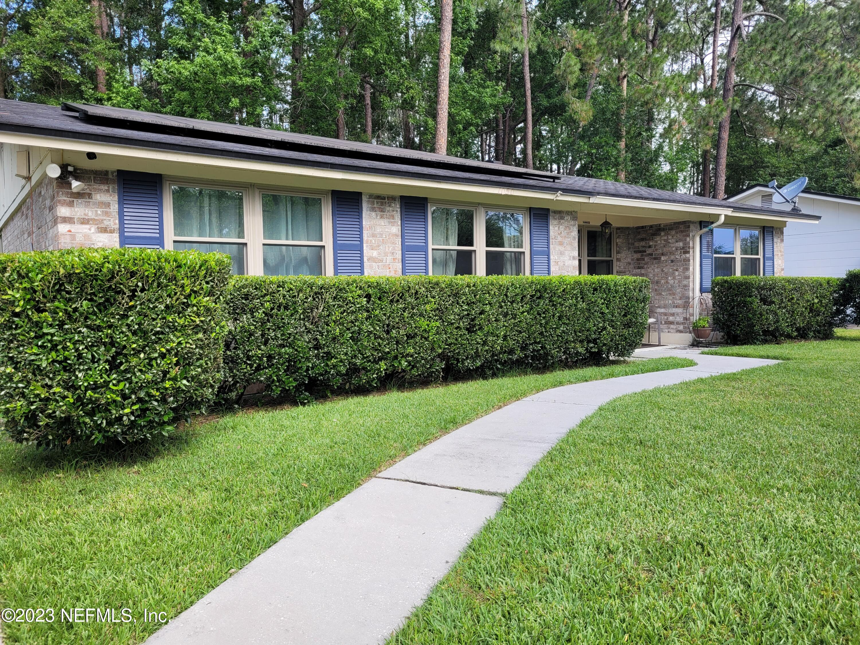1050 Perkins Place Jacksonville, FL 32221 - Photo 2 of 18 a front view of a house with a yard