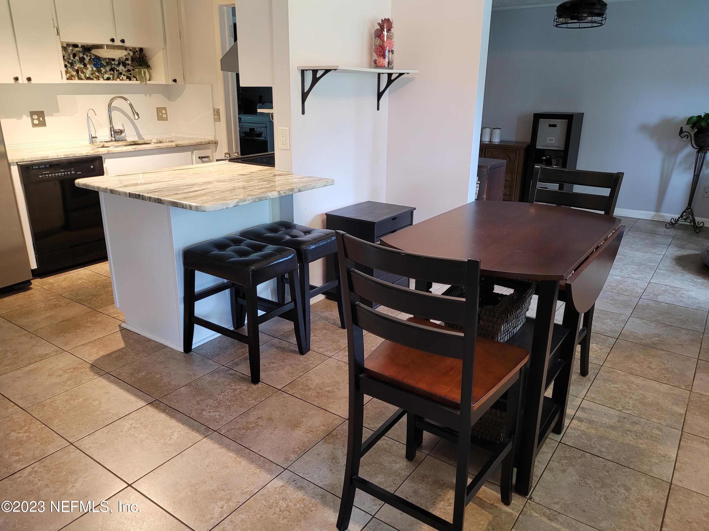 1050 Perkins Place Jacksonville, FL 32221 - Photo 3 of 18 a view of a table and chairs in a kitchen