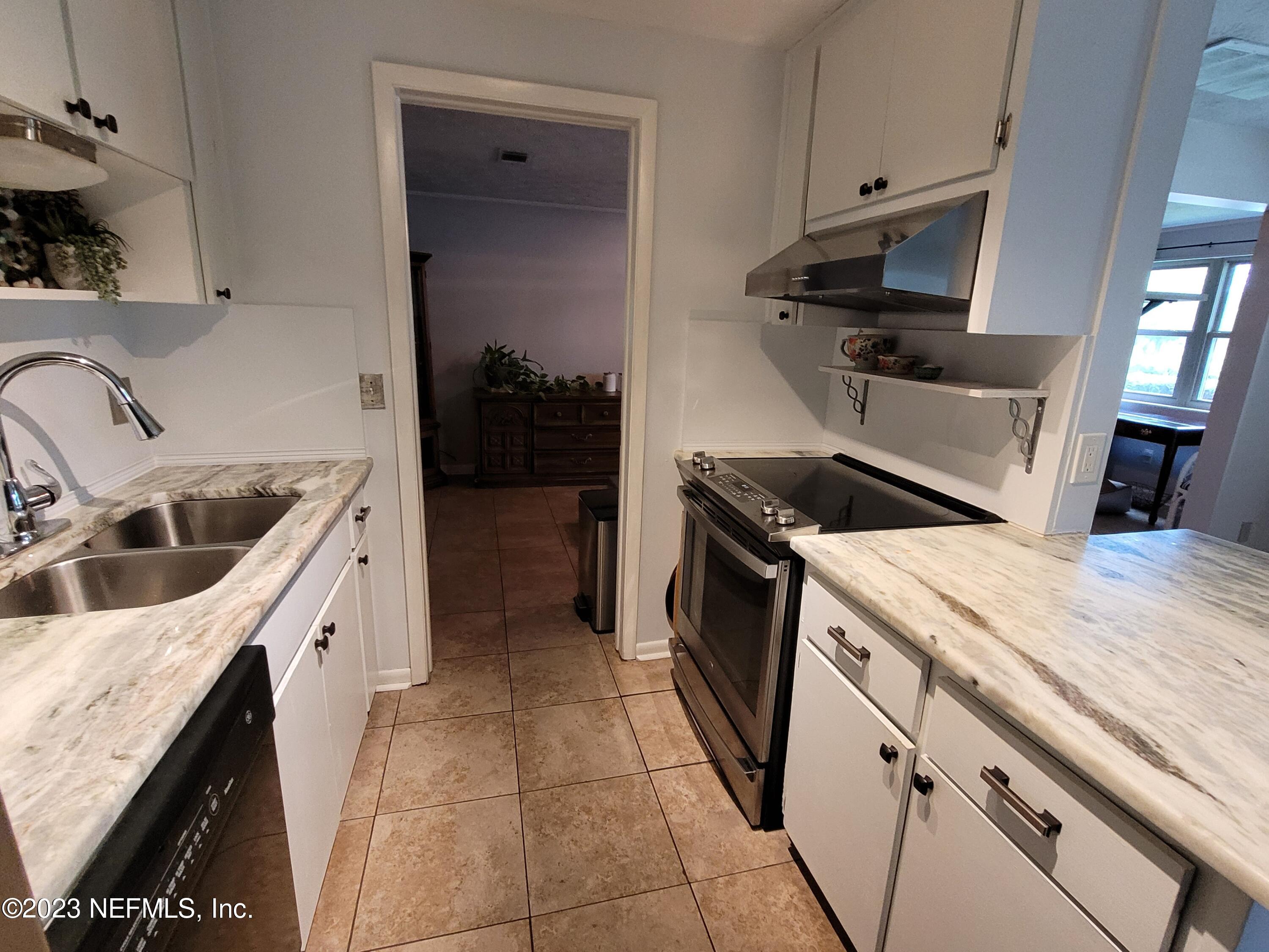 1050 Perkins Place Jacksonville, FL 32221 - Photo 5 of 18 a kitchen with a stove and a sink