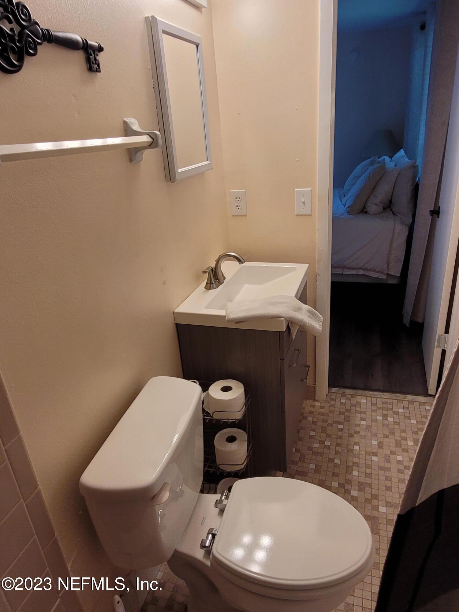1050 Perkins Place Jacksonville, FL 32221 - Photo 9 of 18 a bathroom with a toilet a sink and mirror