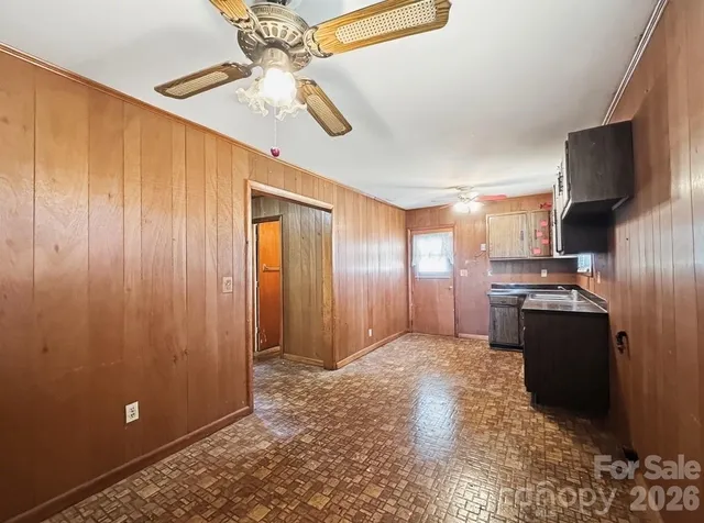 a view of a kitchen with stainless steel appliances granite countertop cabinets and a refrigerator