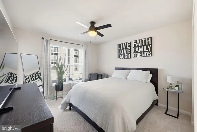 a bedroom with a bed a couch and a window