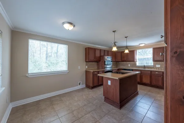 a kitchen with granite countertop a stove and a microwave