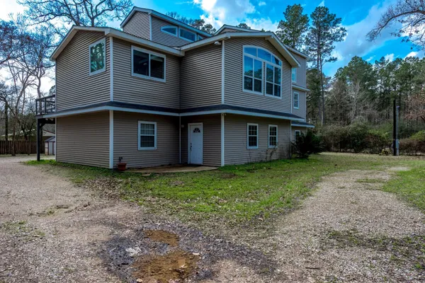 a view of a house with yard and tree s
