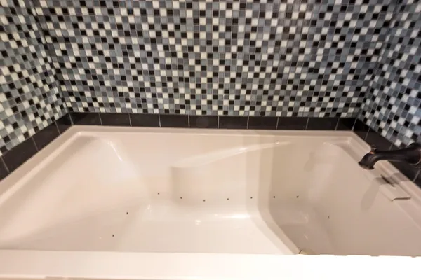 a bathroom with a granite countertop sink a mirror and shower