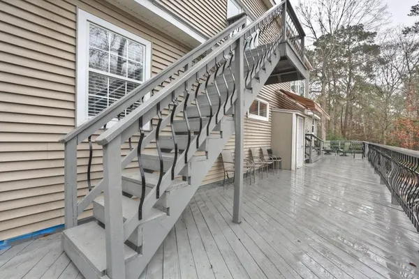 an aerial view of a house with a yard and large tree