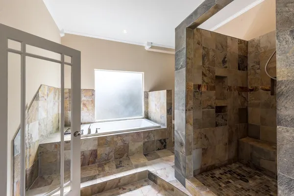 a bathroom with a shower and a sink