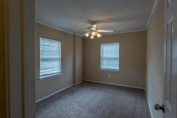 a view of a livingroom with a ceiling fan and window