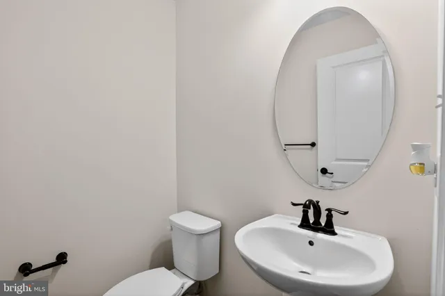 a bathroom with a sink mirror and toilet