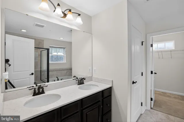 a bathroom with a sink double vanity and a mirror
