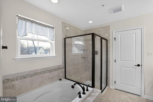a bathroom with a tub and shower