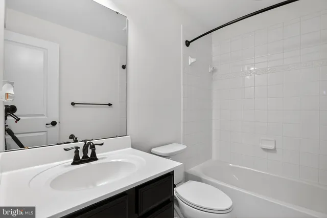 a bathroom with a sink toilet tub and shower