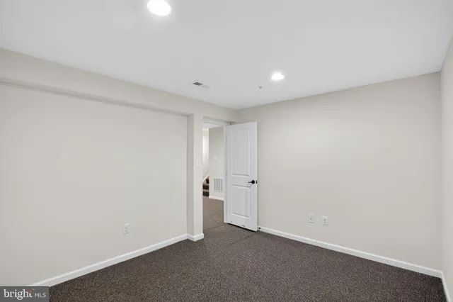 a view of empty room with wooden walls