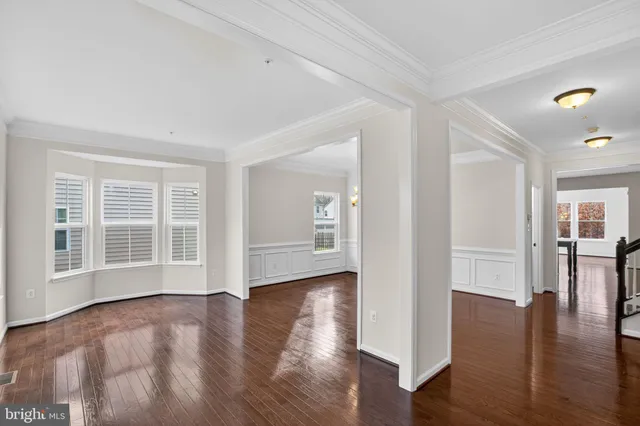 a view of empty room with wooden floor and fireplace