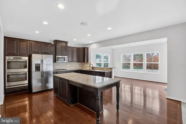 a kitchen with stainless steel appliances granite countertop a stove and a refrigerator