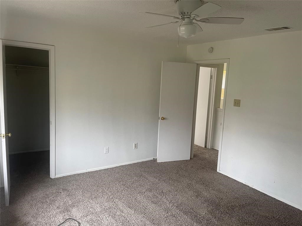5105 Teri Road, Unit A Austin, TX 78744 - Photo 6 of 7 an empty room with closet and a ceiling fan
