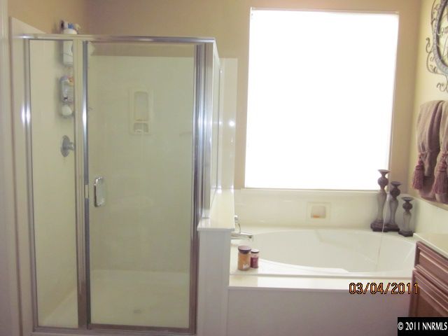 10759 Misty Meadows Drive Reno, NV 89521 - Photo 7 of 11 a bathroom with a bathtub and a shower