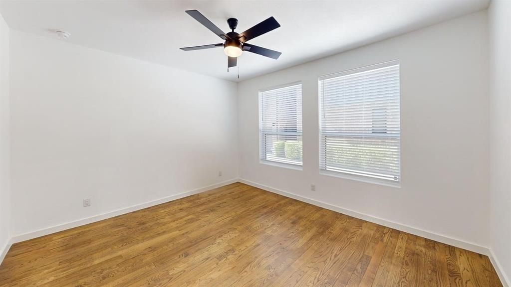 1552 Cosette Drive Dallas, TX 75215 - Photo 12 of 23 Empty room featuring light wood-style floors and a ceiling fan