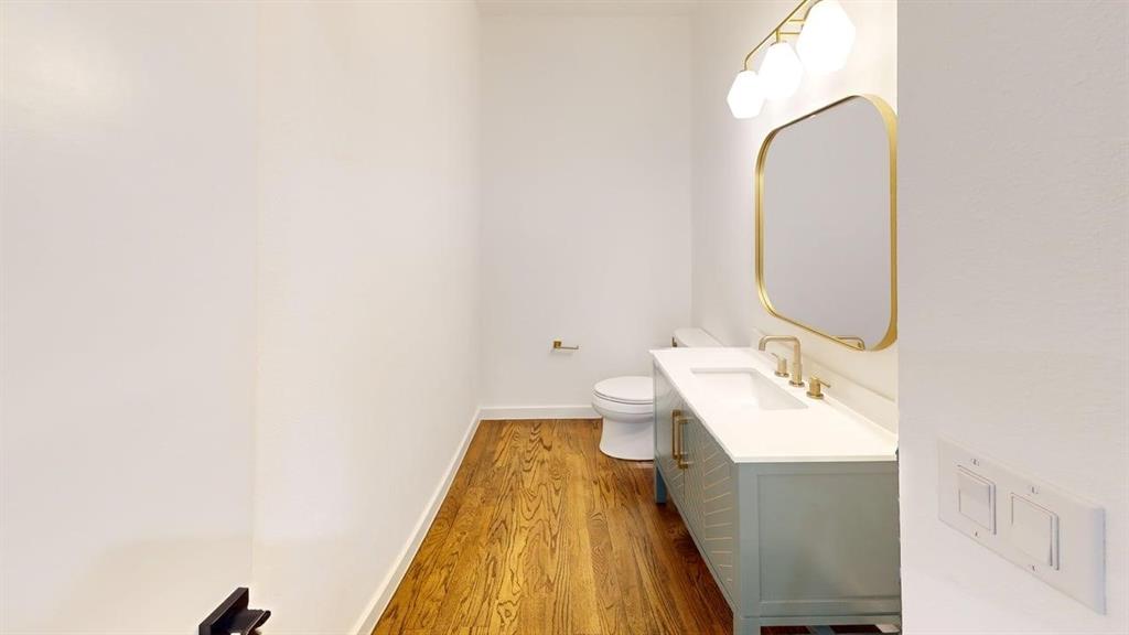 1552 Cosette Drive Dallas, TX 75215 - Photo 13 of 23 Bathroom featuring vanity and dark wood finished floors