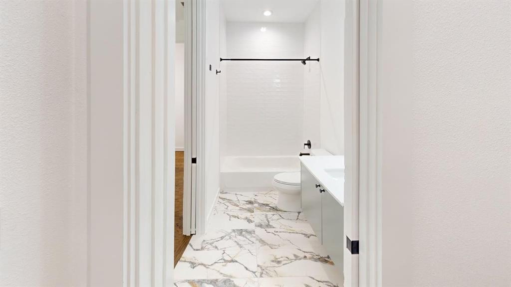 1552 Cosette Drive Dallas, TX 75215 - Photo 14 of 23 Bathroom with vanity, light marble finish flooring, recessed lighting, tub / shower combination, and a textured wall