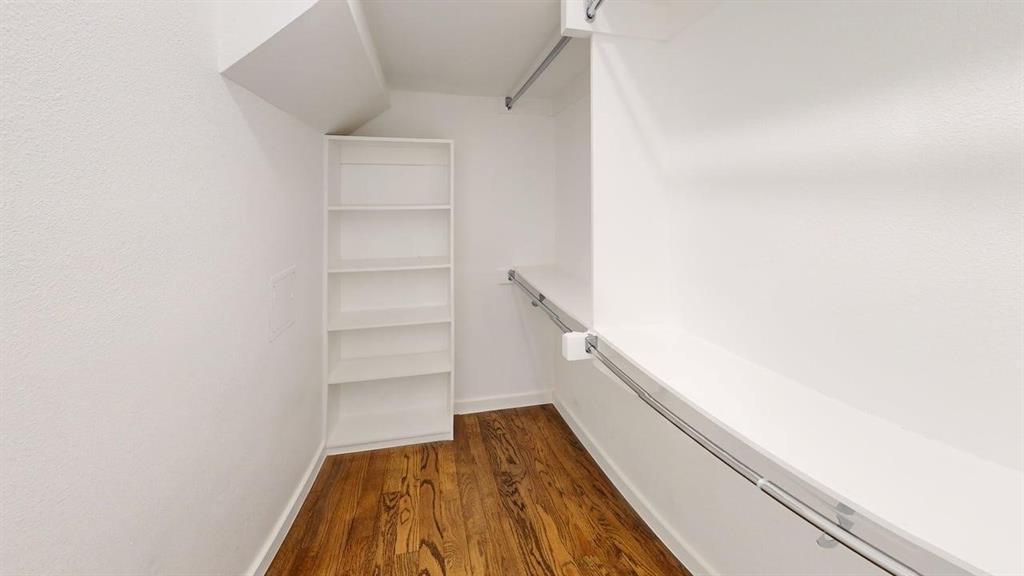1552 Cosette Drive Dallas, TX 75215 - Photo 17 of 23 Walk in closet featuring dark wood-style flooring