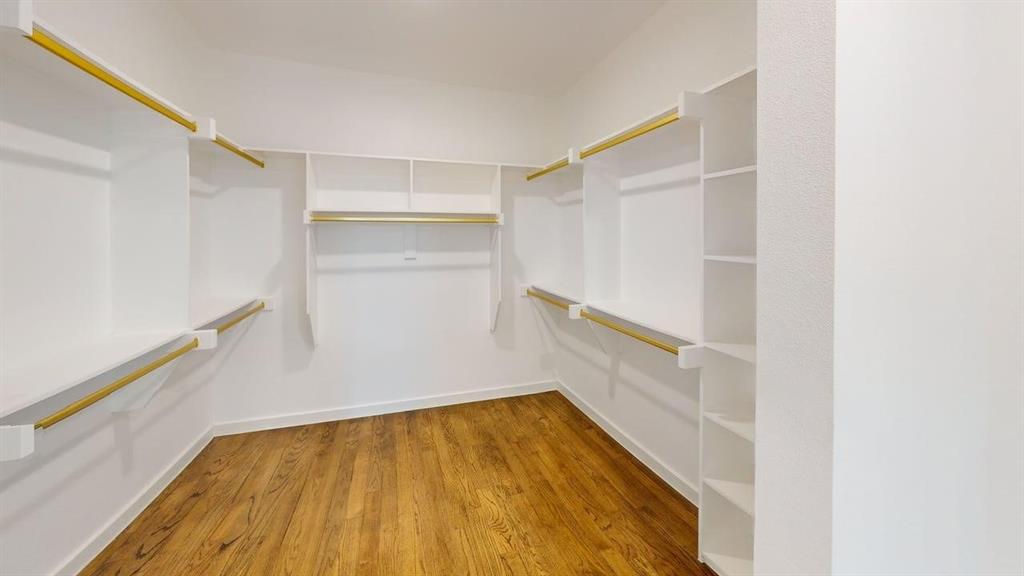1552 Cosette Drive Dallas, TX 75215 - Photo 18 of 23 Walk in closet featuring light wood-style floors