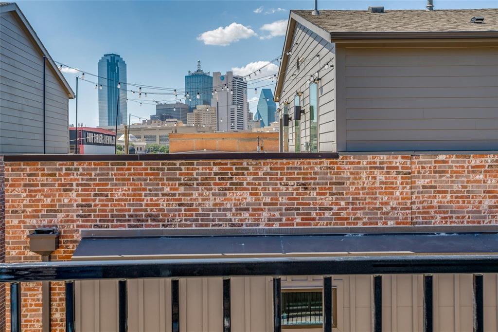 1552 Cosette Drive Dallas, TX 75215 - Photo 21 of 23 Exterior view of city skyline and board and batten siding