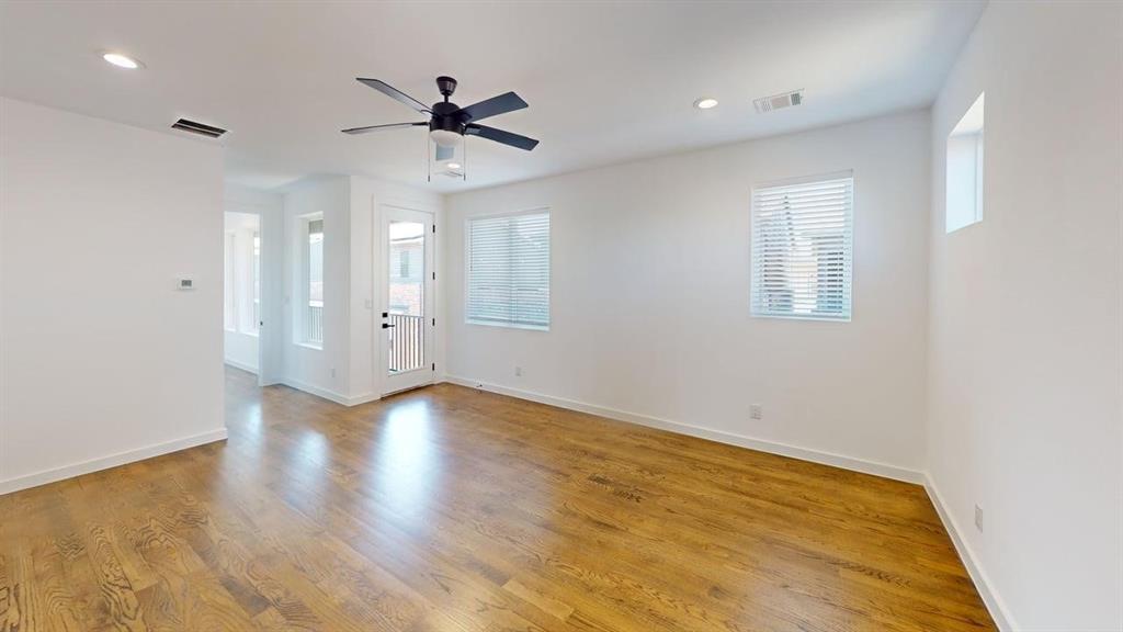 1552 Cosette Drive Dallas, TX 75215 - Photo 6 of 23 Empty room with light wood-type flooring, healthy amount of natural light, a ceiling fan, and recessed lighting